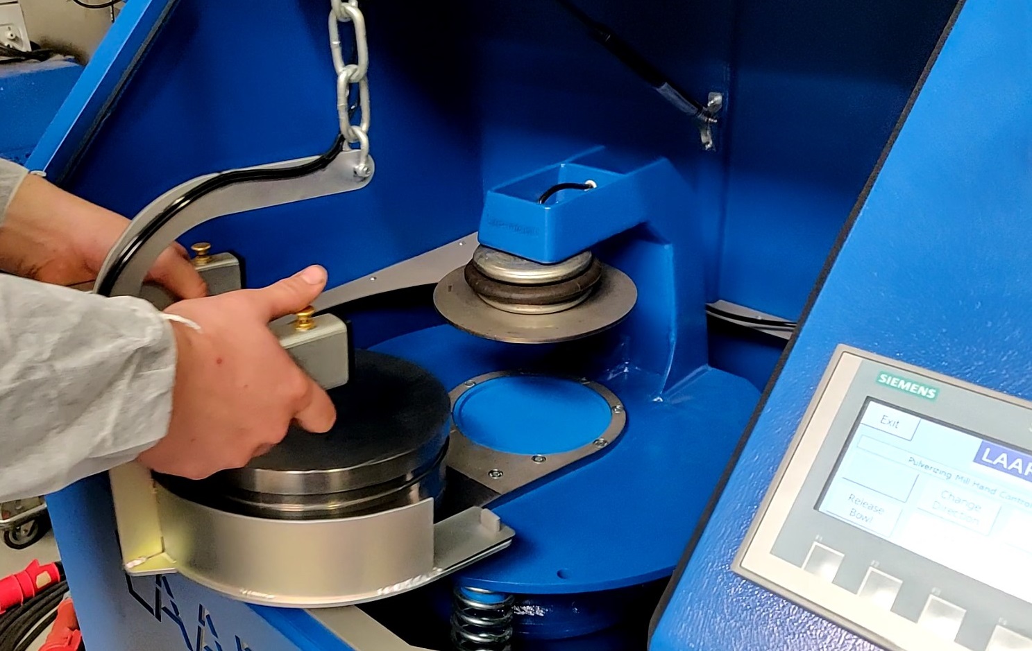 Operator using the Liftboy bowl lifting device with the LAARMANN LM2000 Pulveriser Ring Mill